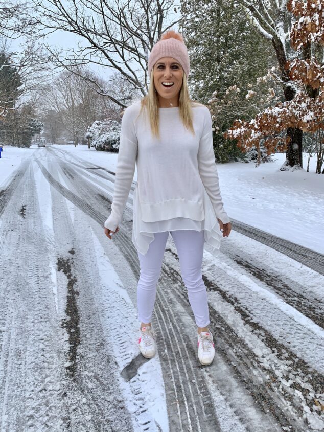 woman wearing white standing in the snow in the winter