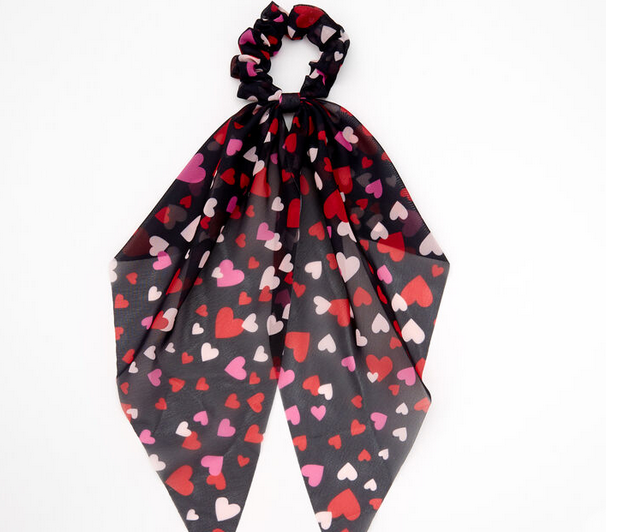 This classic scarf-style hair scrunchie is all dressed up for Valentine's Day! It's printed all over with pink, white, and red hearts.