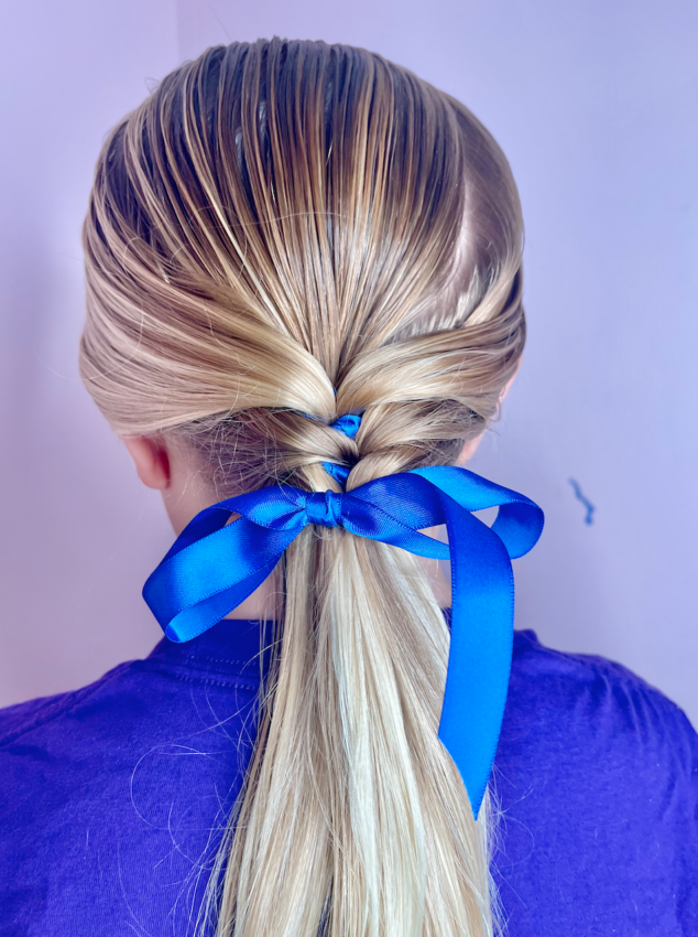 The cute, simple art of a girl with brown hair tied with a ribbon